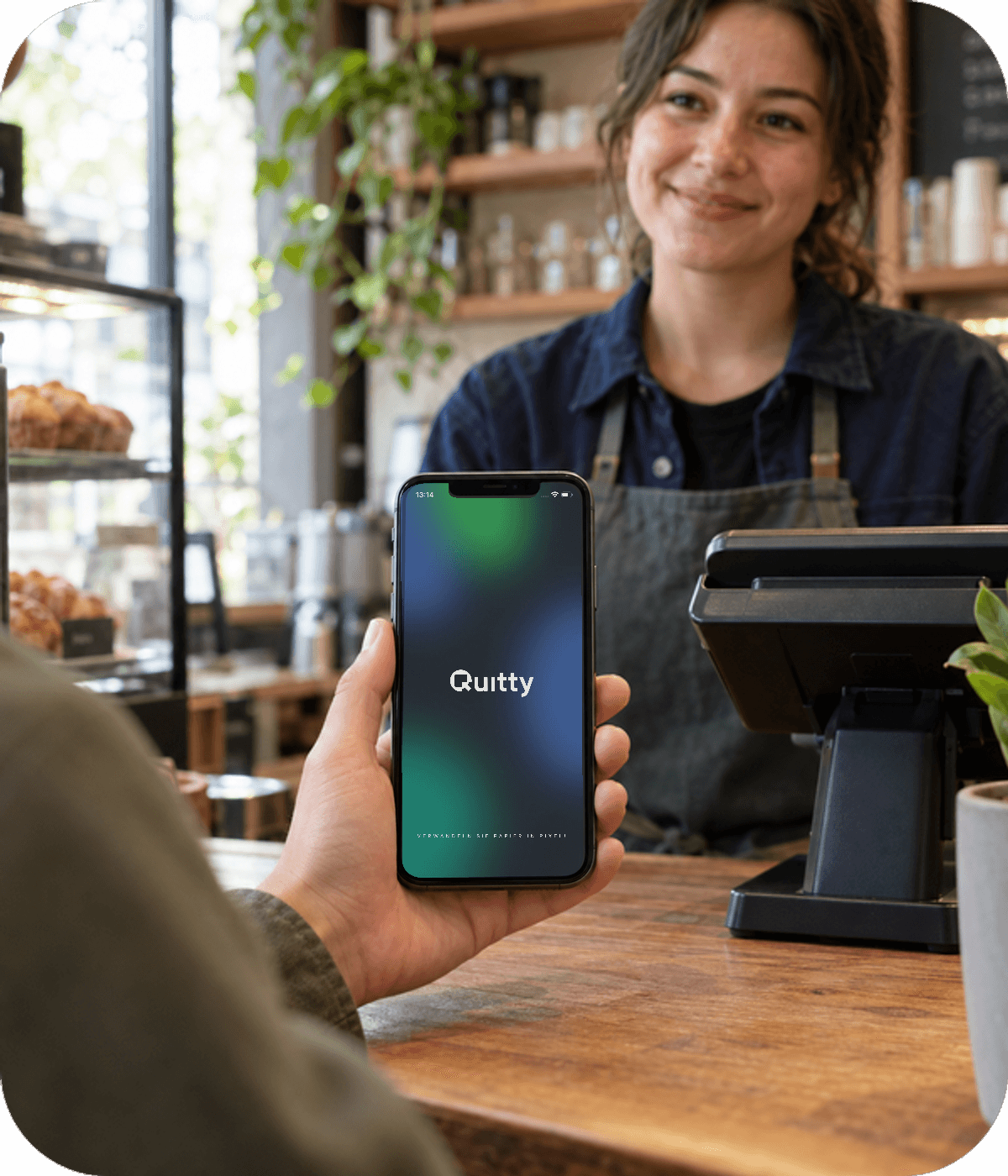 Smartphone showing the original Quitty home screen at a cafe counter